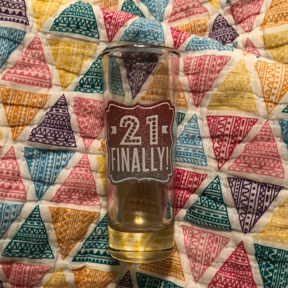 A shot glass that reads finally 21